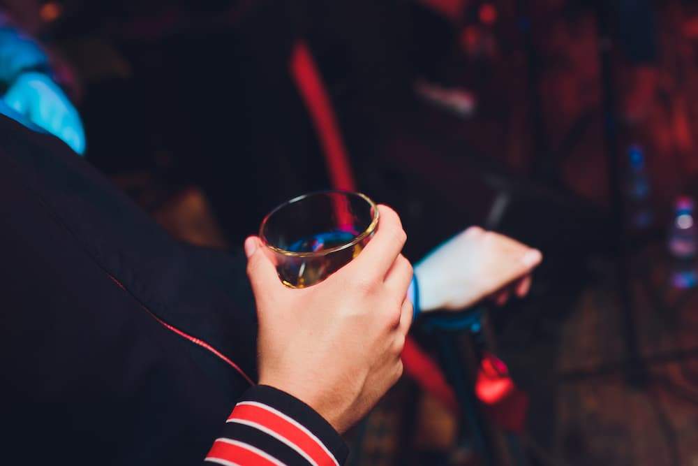 red sleeve holding a drink